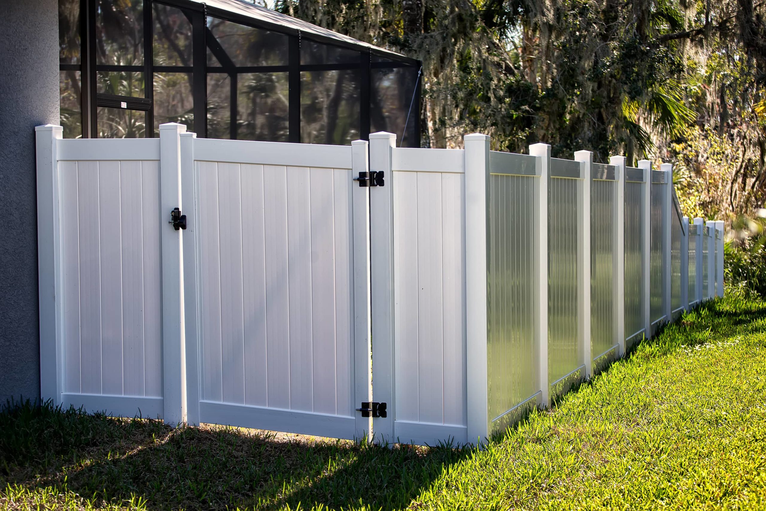 This is an image of a white plastic fence with a gate that opens.