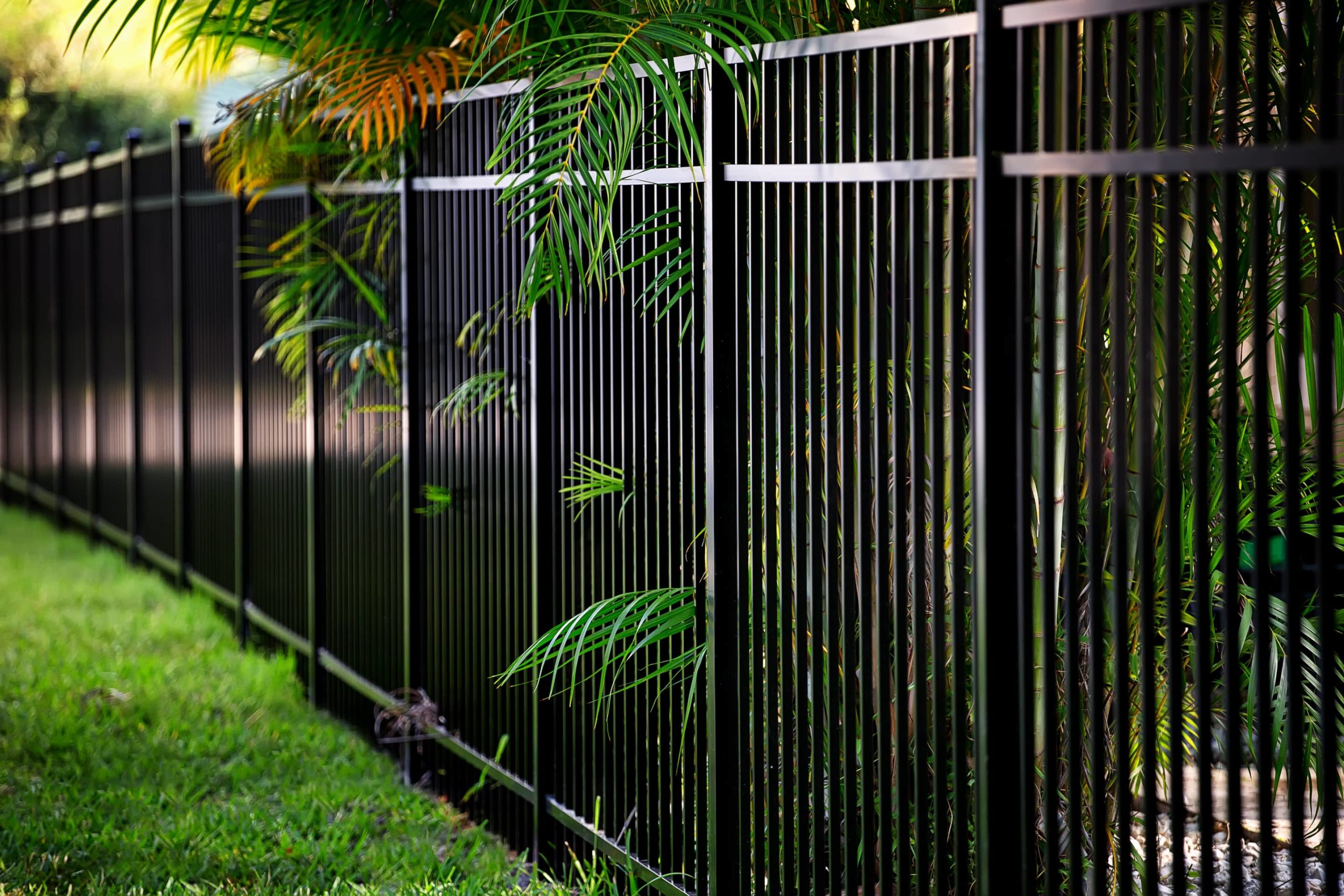 This image is of a tall metal fence surrounding a property.